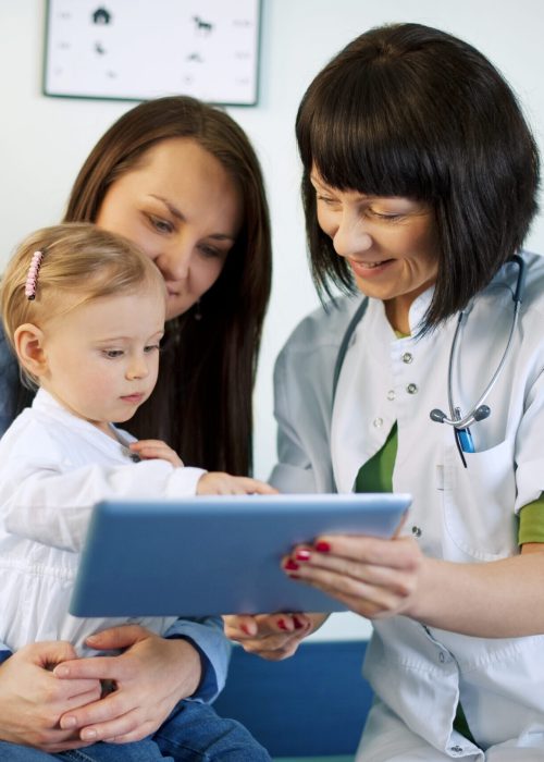 Doctor showing mother's medical results on the tablet